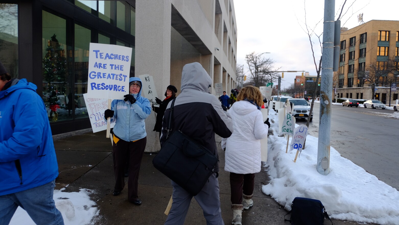 Rochester teachers protest planned job cuts outside district headquarters on Thursday.